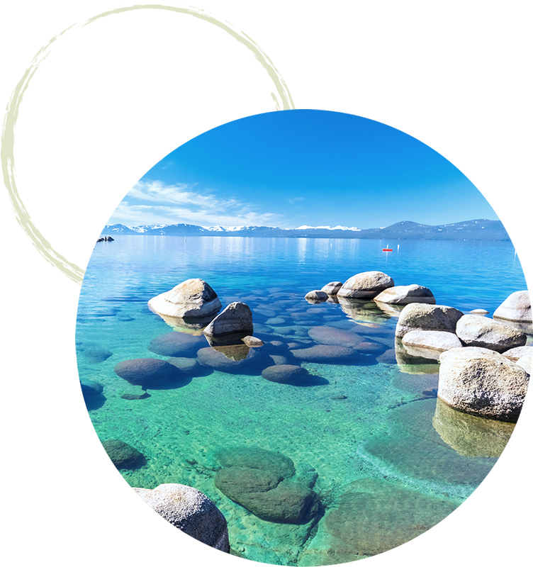 Clear blue water and large rocks on the shore at Lake Tahoe